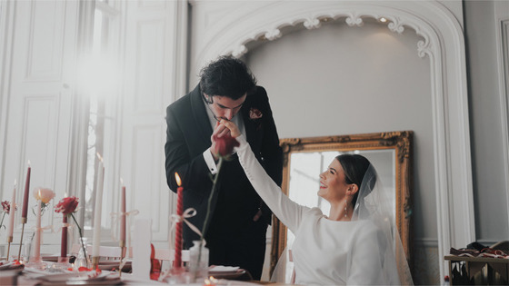 Groom kisses brides hand at top table